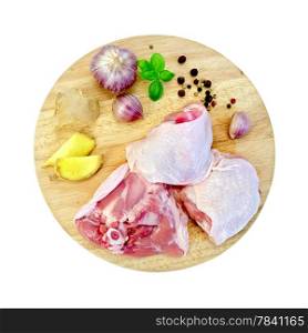 Chicken thigh cut into round board with garlic, basil, ginger isolated on white background