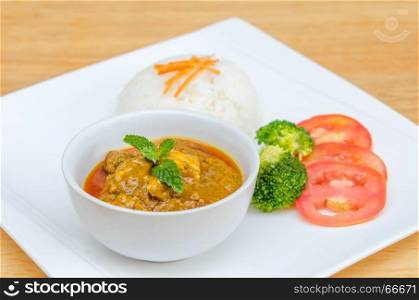 chicken tikka masala . chicken tikka masala served with rice and vegetables