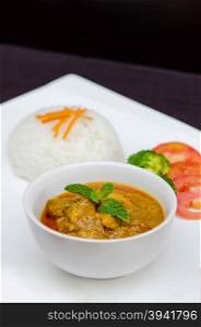 chicken tikka masala served with rice and vegetables. chicken tikka masala