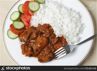 Chicken tikka masala with basmati rice and a salad from above