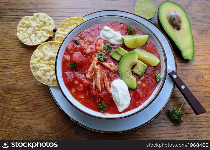 Chicken tortilla chili soup with beans, avocado, lime, . Mexican traditional dish . Top view. Chicken tortilla chili soup with beans, avocado, lime, . Mexican traditional dish