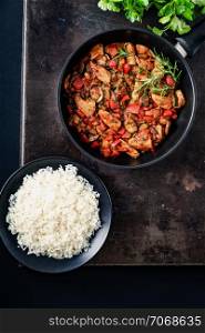 Chicken vegetable pan with rice, fresh ingredients and herbs, finely seasoned