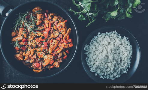 Chicken vegetable pan with rice, fresh ingredients and herbs, finely seasoned