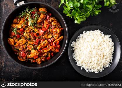 Chicken vegetable pan with rice, fresh ingredients and herbs, finely seasoned