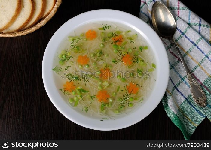 Chicken vermicelli soup with green peas and carrots