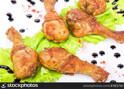 chicken wings closeup at white plate with lettuce