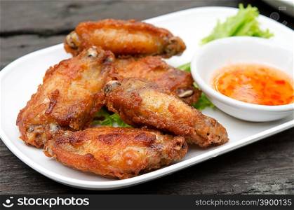 chicken wings on white dish wood background.