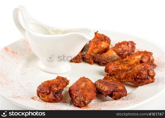 chicken wings with sauce closeup at white plate