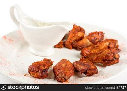 chicken wings with sauce closeup at white plate
