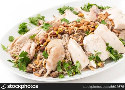 Chicken with spiced rice and nuts, garnished with parsley, a Lebanese celebratory dish.