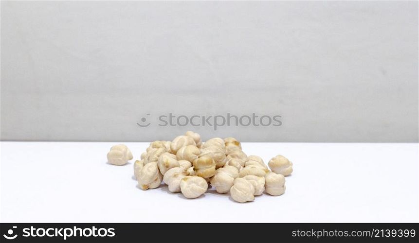 chickpeas in a pile, in front of a white background