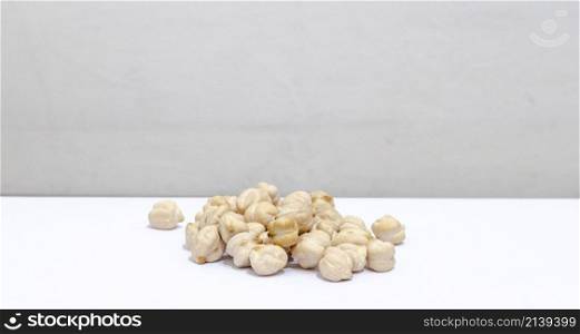 chickpeas in a pile, in front of a white background