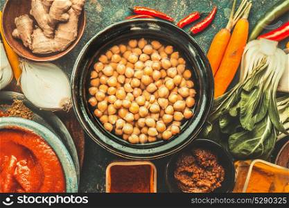 Chickpeas in bowl and various healthy cooking ingredients. Vegan or vegetarian food and eating concept