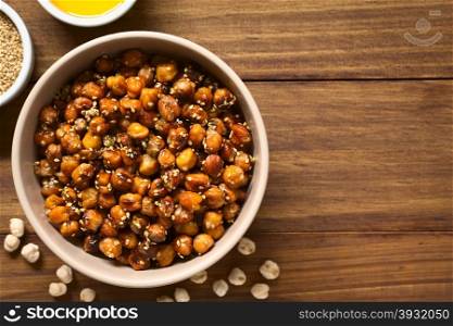 Chickpeas roasted with sesame and honey, photographed overhead on wood with natural light