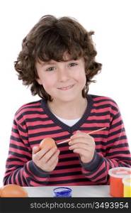 Child adorable adorning Easter eggs on a white background