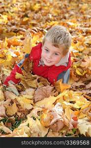 child among fallen leaves