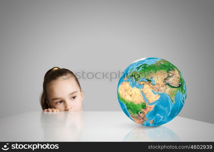 Child and Earth planet. Little cute girl looking at globe. Elements of this image are furnished by NASA