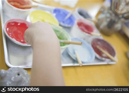 Child and paint pots
