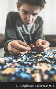 Child and puzzle. Pile puzzles