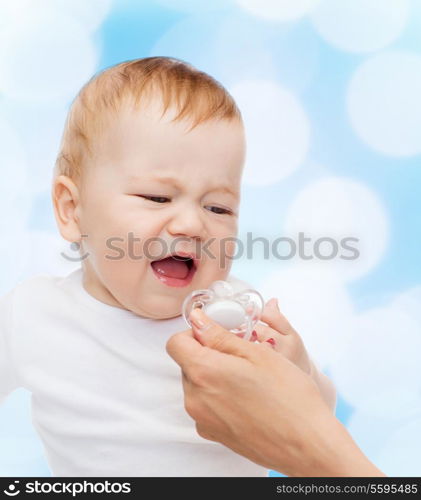 child and toddle concept - crying baby with dummy