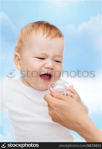 child and toddle concept - crying baby with dummy