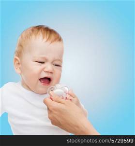 child and toddle concept - crying baby with dummy