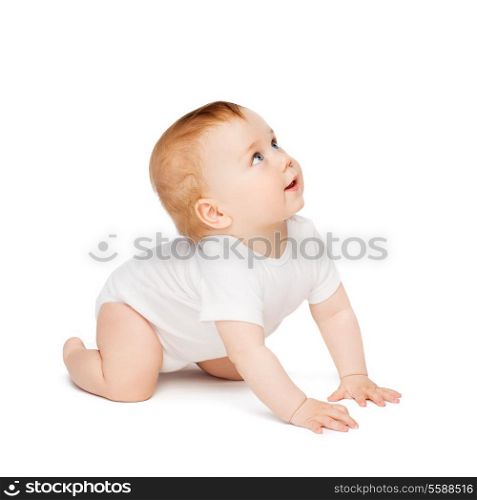 child and toddler concept - crawling curious baby looking up
