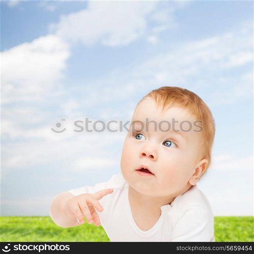 child and toddler concept - curious baby looking side
