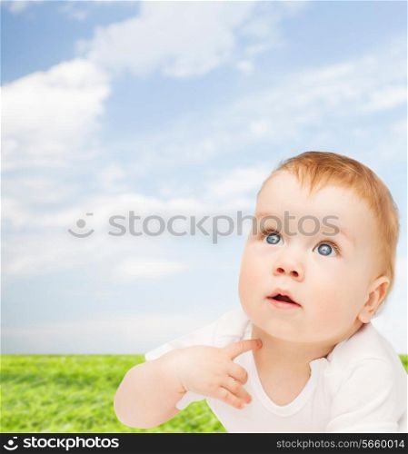 child and toddler concept - curious baby looking up
