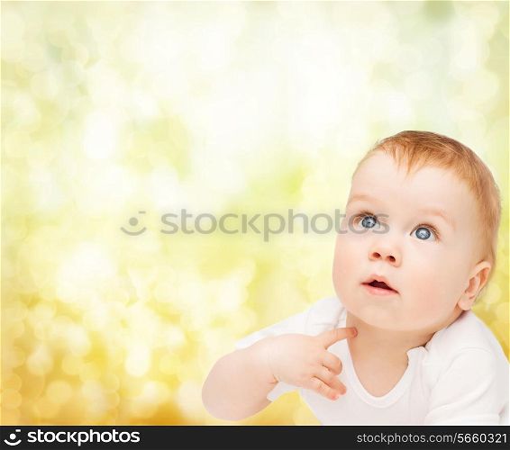 child and toddler concept - curious baby looking up