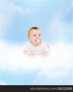 child and toddler concept - smiling baby lying on cloud with dummy in mouth