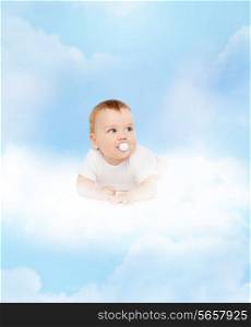 child and toddler concept - smiling baby lying on cloud with dummy in mouth