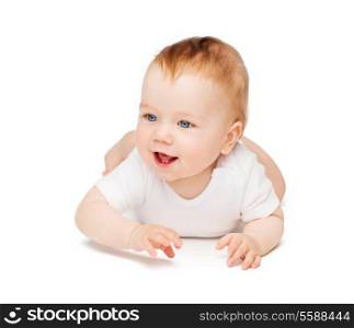 child and toddler concept - smiling baby lying on floor