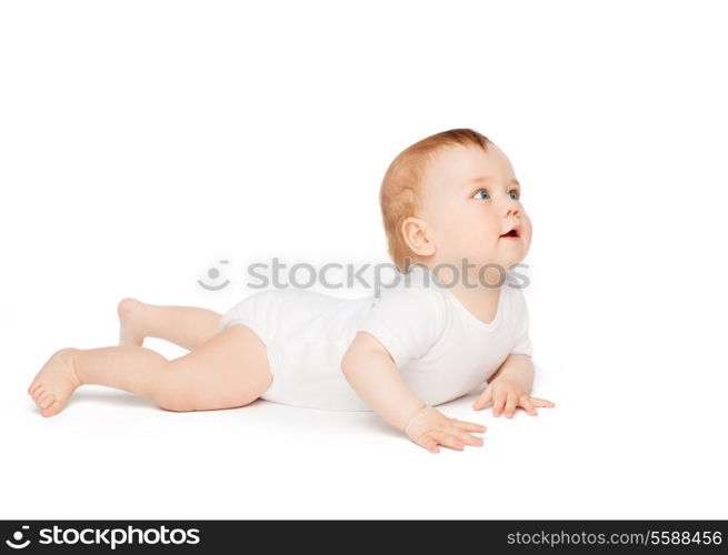 child and toddler concept - smiling baby lying on floor and looking up