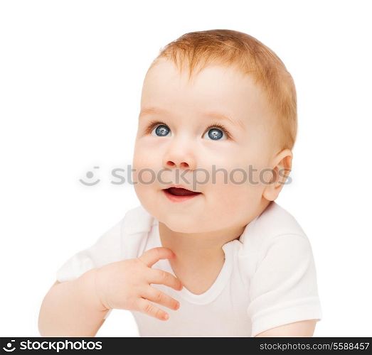 child and toddler concept - smiling baby lying on floor and looking up