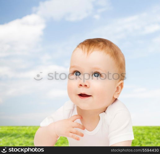 child and toddler concept - smiling baby lying on floor and looking up