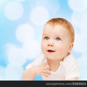 child and toddler concept - smiling baby lying on floor and looking up