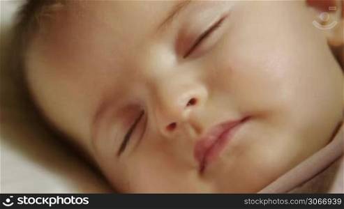 Child at home, cute baby girl sleeping in crib in bedroom