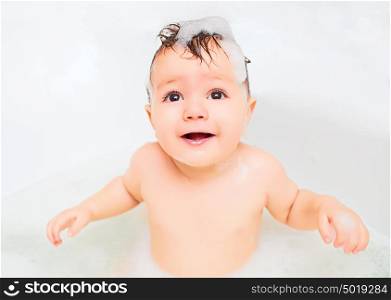 child bathes in a bathroom