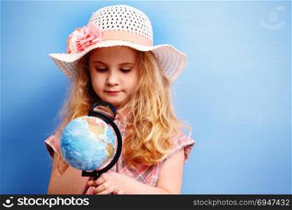 Child blonde girl study the globe. Travel and adventure concept. Child blonde girl study the globe. Travel and adventure concept.