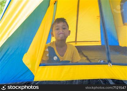 child boys are in the tent during camping.