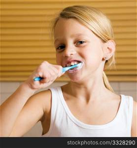 Child brushing teeth in bathroom