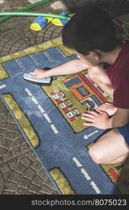 Child clean carpet. Exterior shot