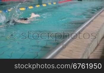 child competing in a swimming race