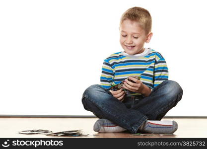 Child cute boy playing with educational cards on floor