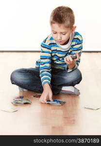 Child cute boy playing with educational cards on floor