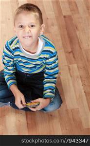 Child cute boy playing with educational cards on floor at home