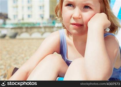Child daydreaming on beach