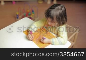 child drawing and having fun in kindergarten