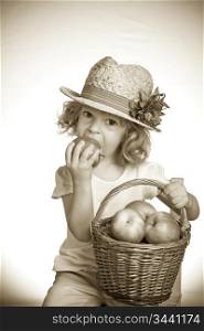 Child eating apple in studio. Vintage toned